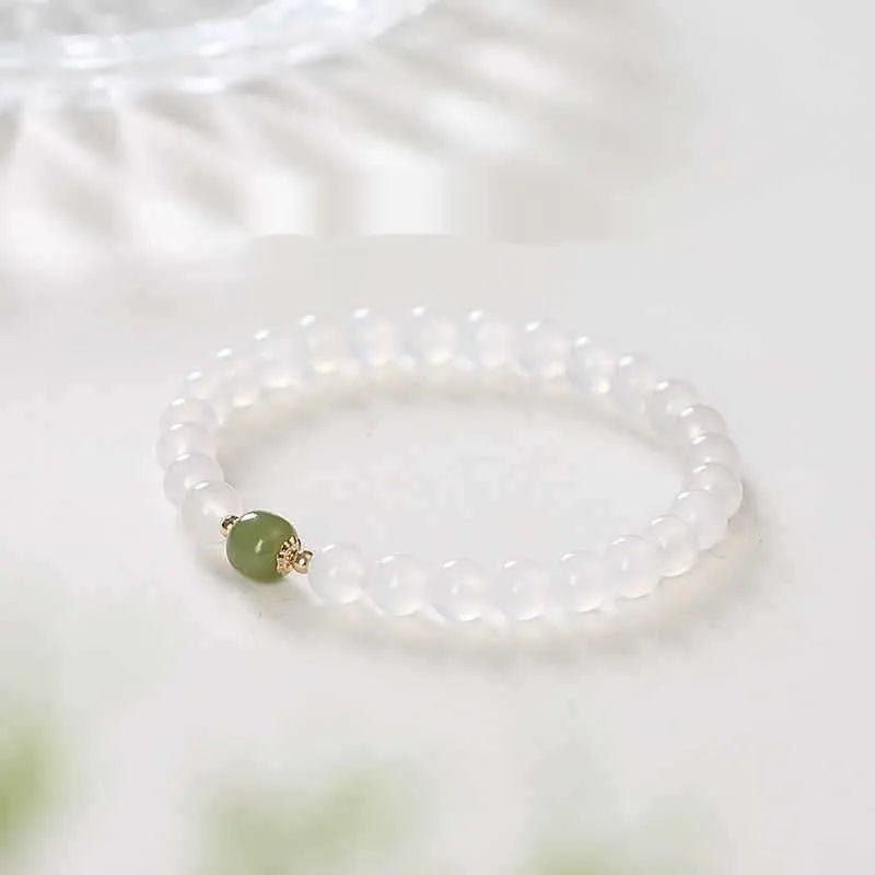 Handmade white agate crystal bracelet with cinnabar accents showing 6mm and 8mm bead sizes
