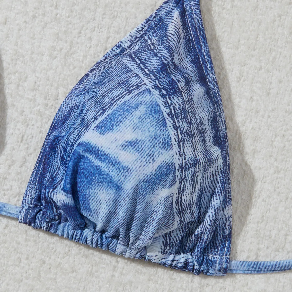 Women's denim blue printed bikini set with strap design, shown as a two-piece swimsuit.