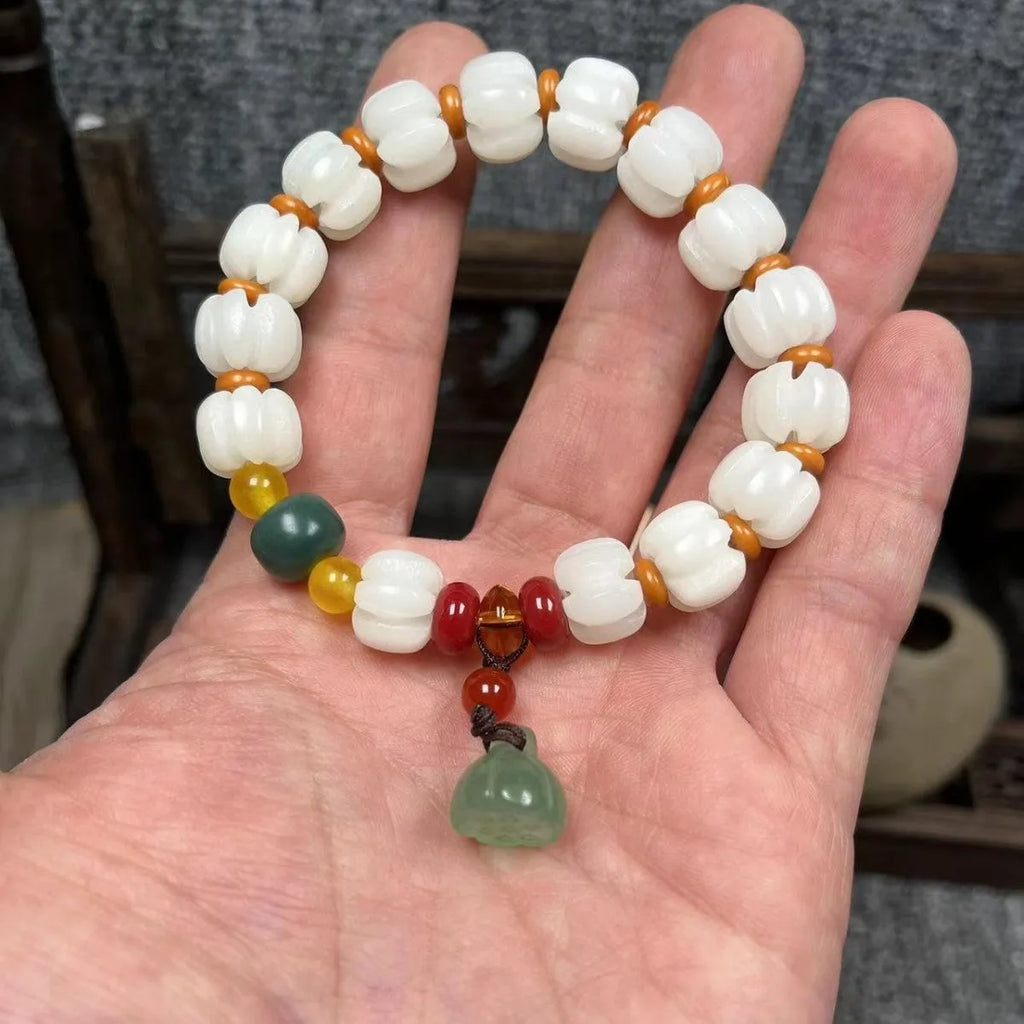 Bodhi root bracelet with carved lotus, pumpkin, and white jade beads in multiple sizes