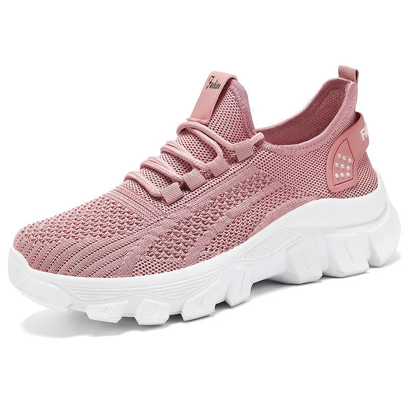 Women's white Flyknit running shoes with a thick PVC sole and lace-up front.
