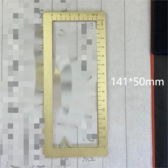 Solid brass square calligraphy paper weight with hand engraved surface on desk