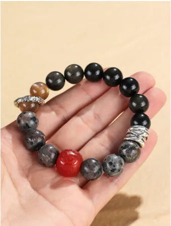 Gold obsidian flame stone and red agate unisex bracelet with original Wukong design on neutral background