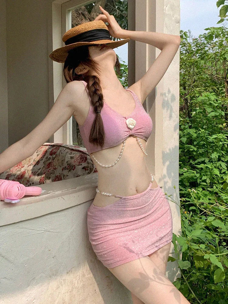 Women's pink and black three-piece polyester bikini swimsuit for swimming.