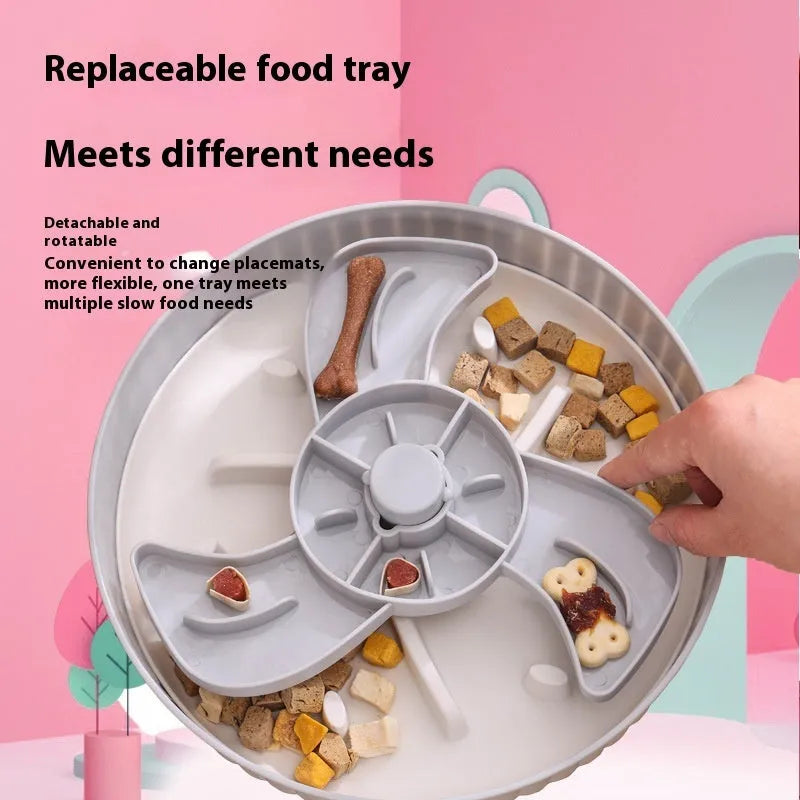 Rotating plastic pet slow feeder bowl with silicone anti-choke mat in windmill pattern.