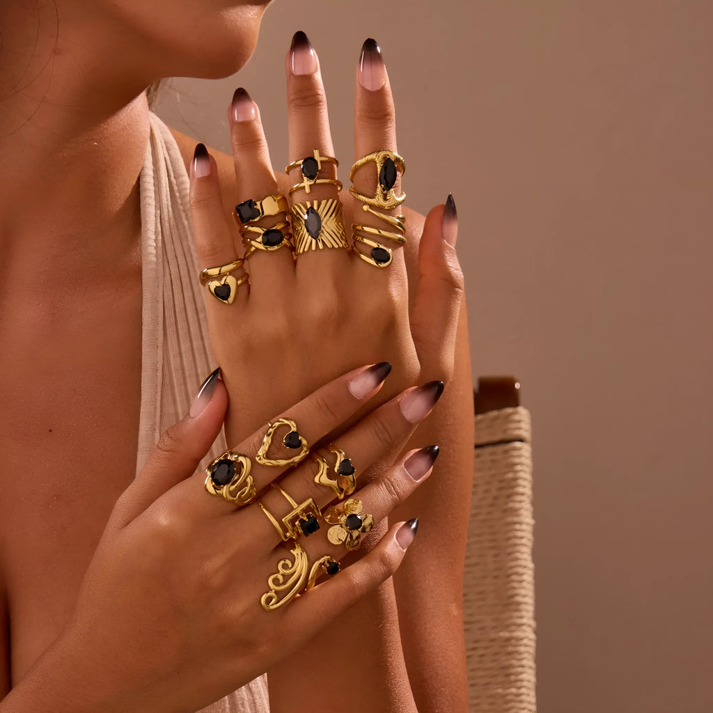Women's adjustable titanium steel ring with geometric shape and inlaid zircon detailing on a finger.