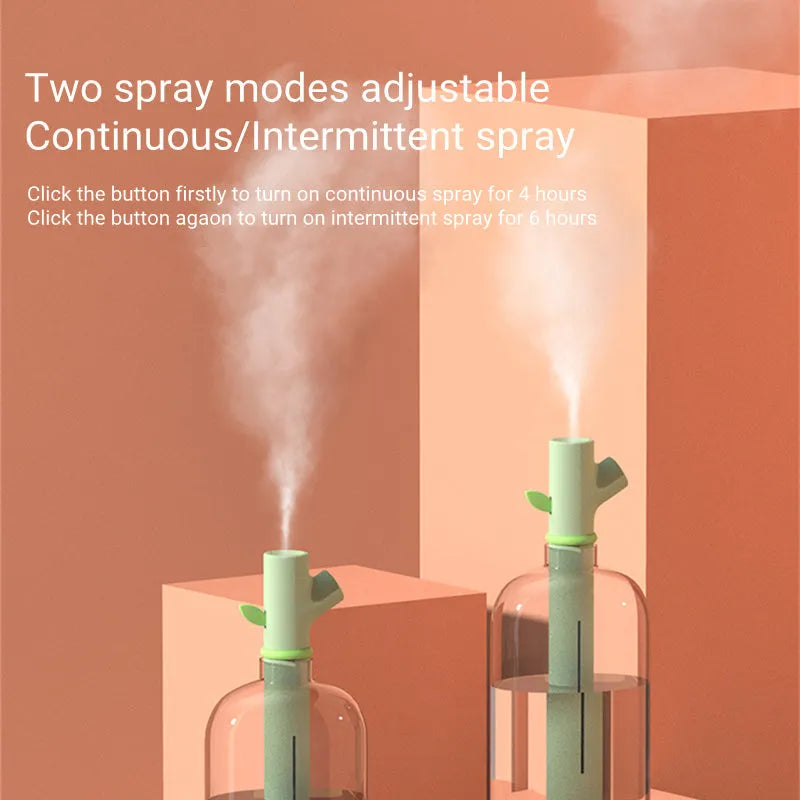 Transparent plastic mini USB branch humidifier on desk with mist output