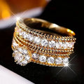 Two gold geometric zinc alloy rings with electroplated finish on white background