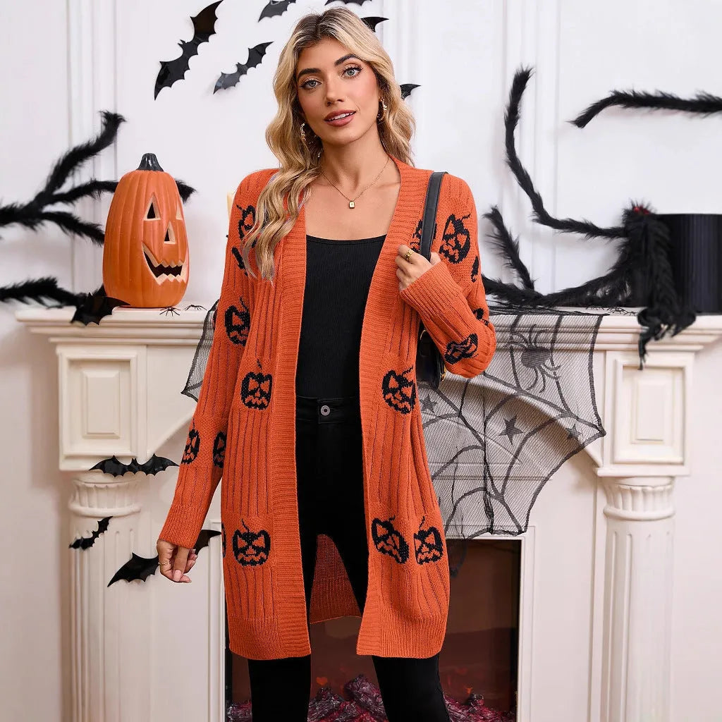Women's black Halloween cardigan with jacquard-knitted orange pumpkin head pattern, shown as a straight-cut medium-length coat.