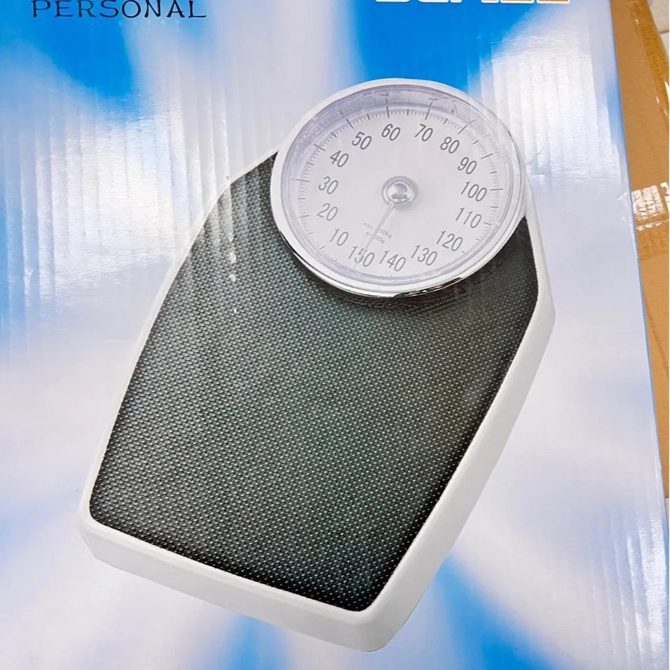 Black mechanical body weight scale with large dial showing weight measurements