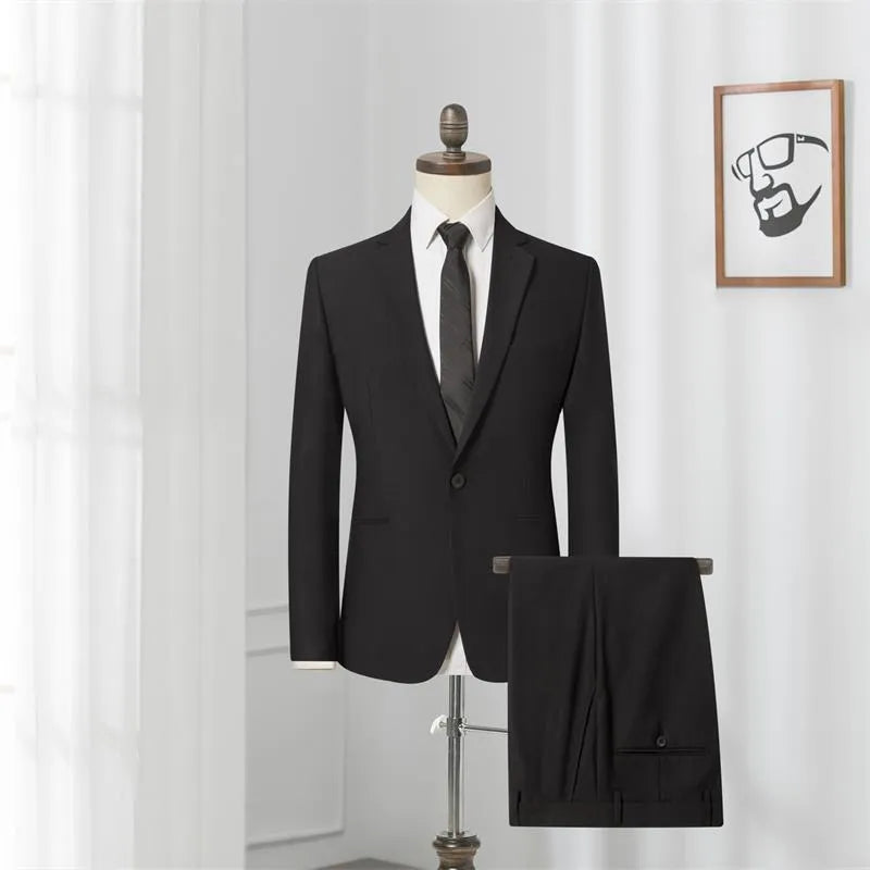 Men's black slim-fit one-button business suit with flat collar and rear slit on a hanger.