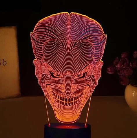 USB-powered 3D acrylic LED lamp showing colour gradient effect, with remote control and base on a desk.