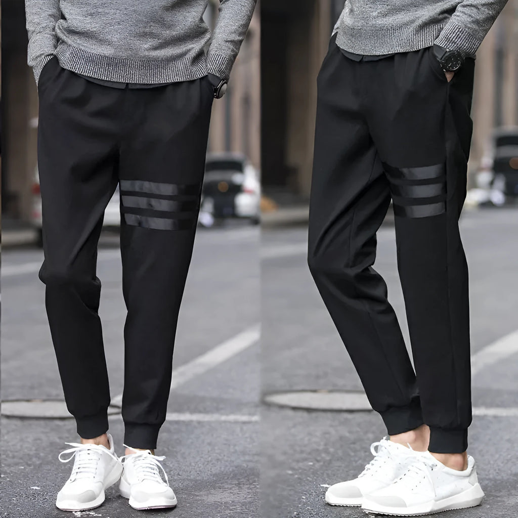 Men's casual slim sweatpants in black with elastic waistband and drawstring, side pockets, tapered leg, polyester fibre fabric