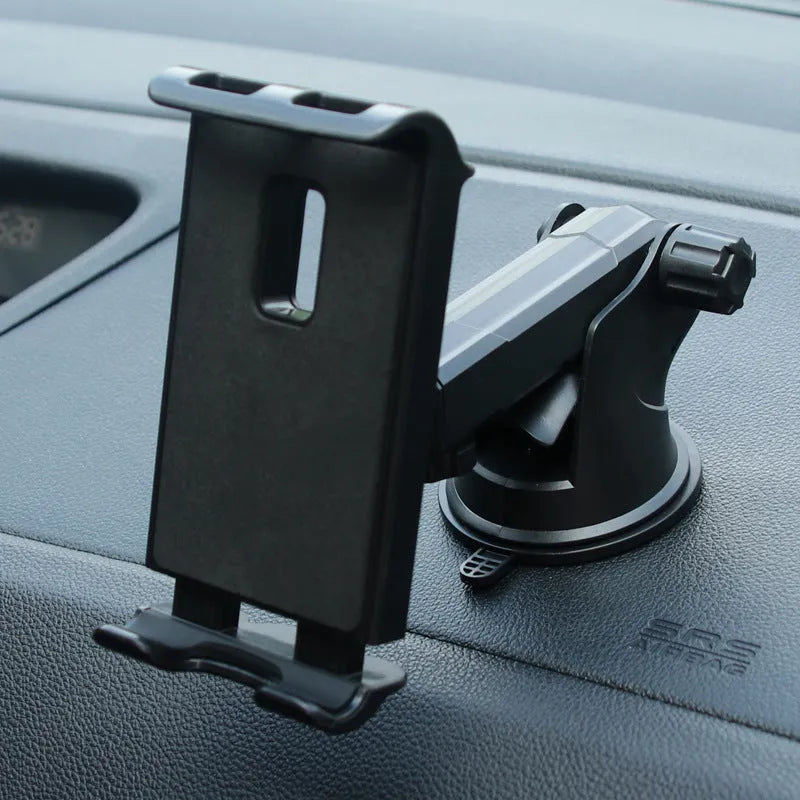 Black tablet PC universal stand car bracket mounted on dashboard centre console holding a tablet