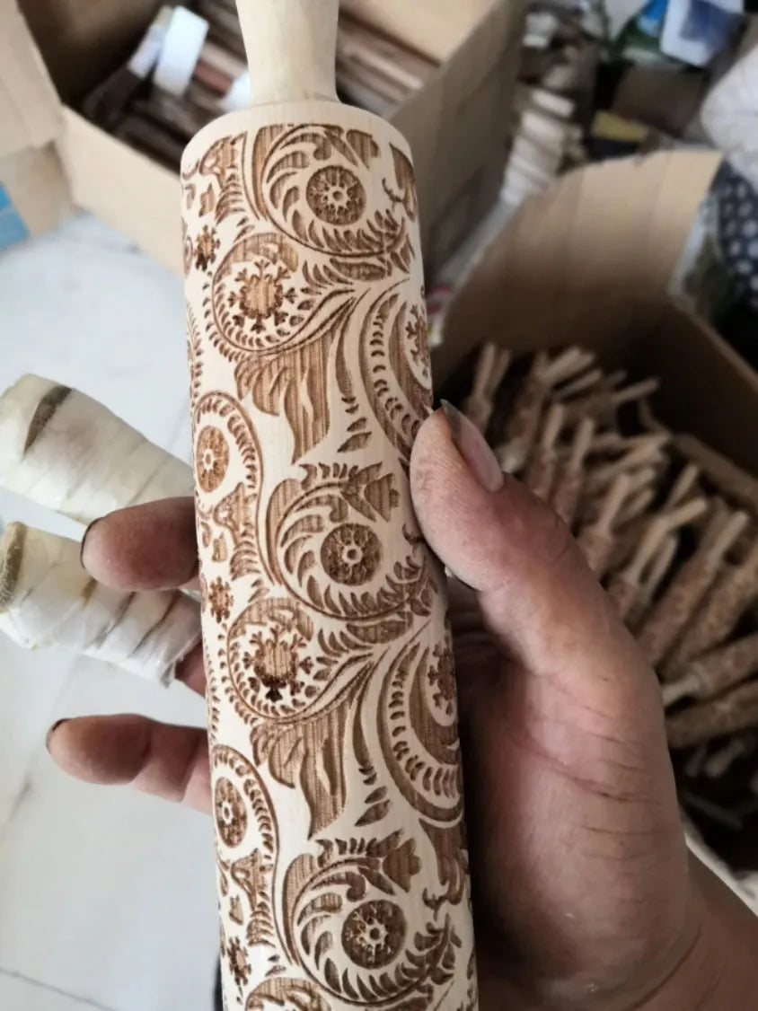Natural wooden rolling pin with Christmas embossing patterns, 45 cm length, on a light background