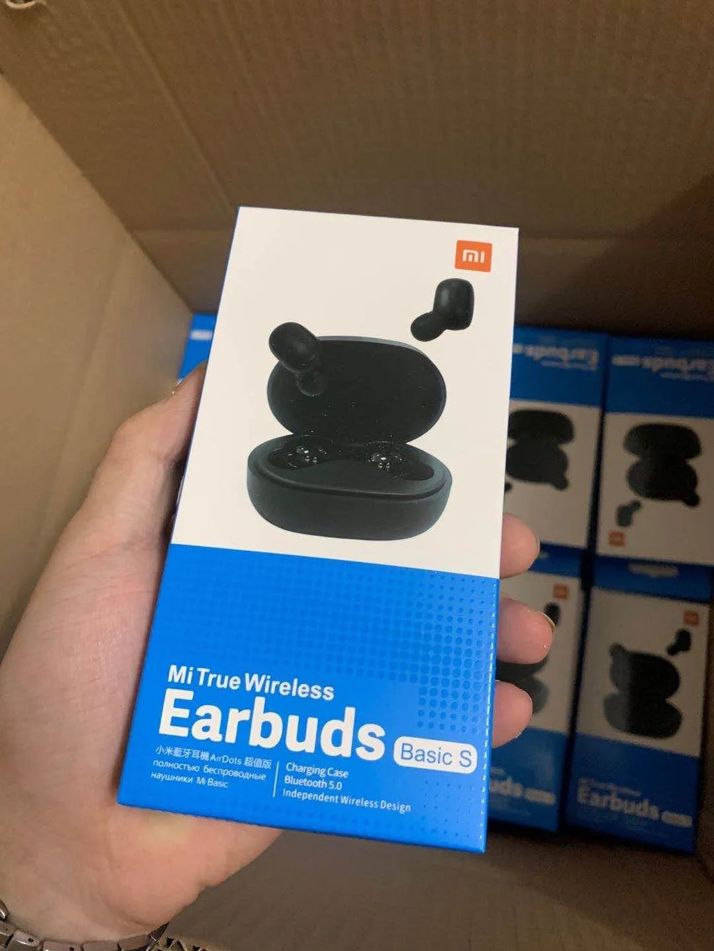 Redmi AirDots True Wireless black earbuds and charging case on a white background.