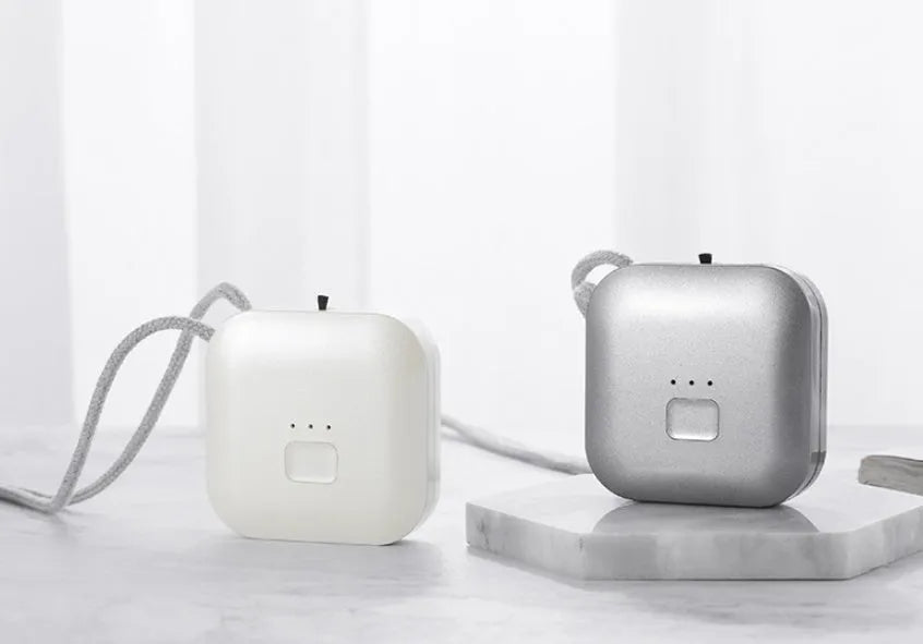 Mini USB portable air purifier necklace in blue colour, showing wearable design and single button.