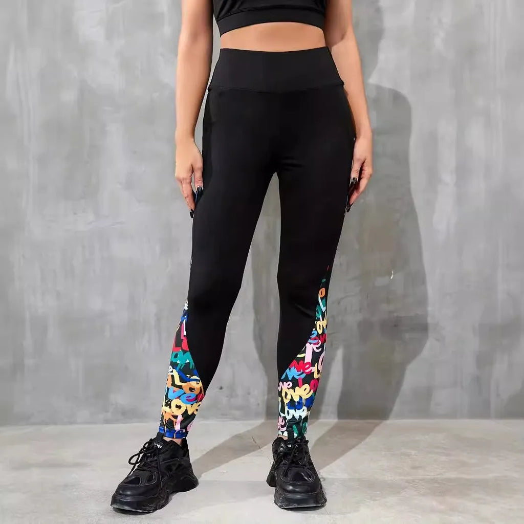 Woman wearing black ribbon letters colour contrast patchwork high waist yoga leggings with pocket