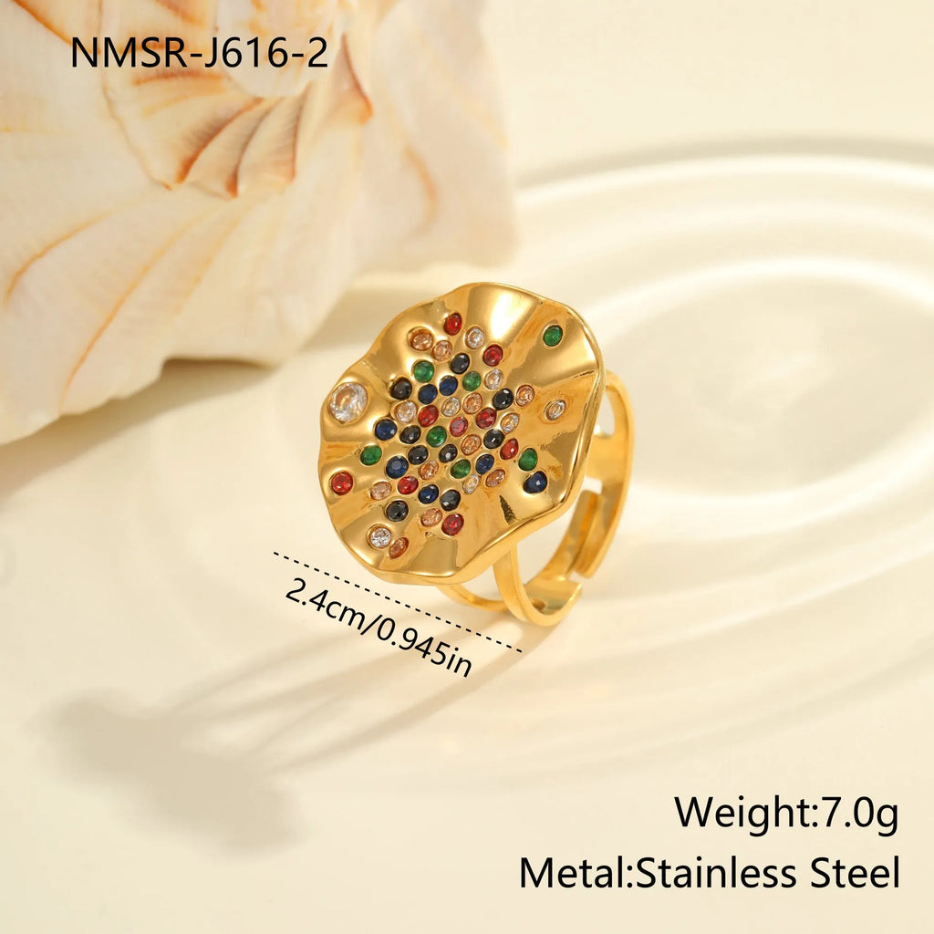 Geometric pleated stainless steel ring with colourful inlaid crystals on an adjustable open band.