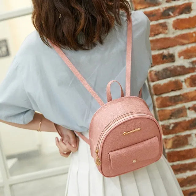 Women's small PU shoulder backpack in solid colour with convertible strap design and zipper closure