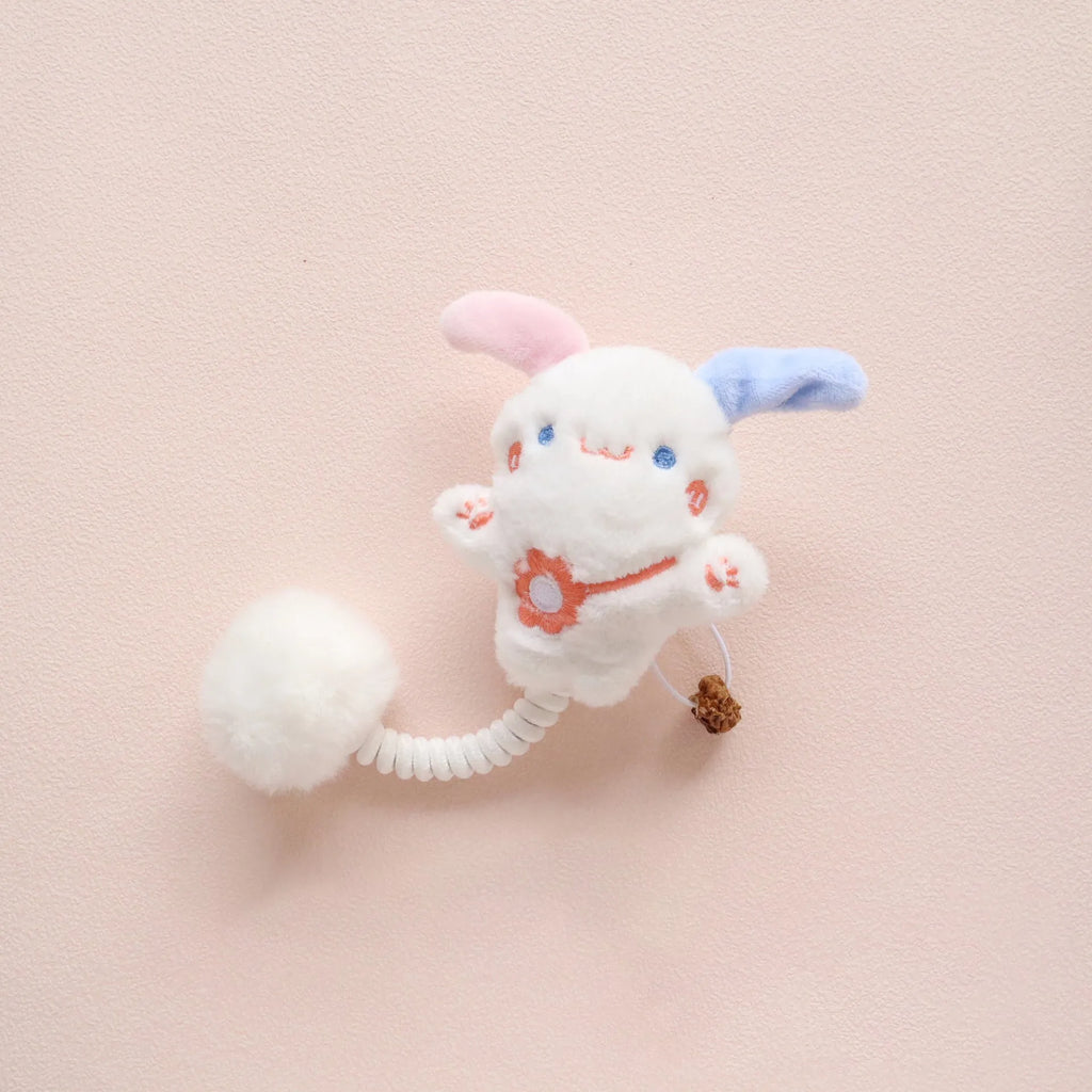 4-in-1 cat toy with plush animal, silvervine fruit, stretchable spring and fuzzy ball on white background