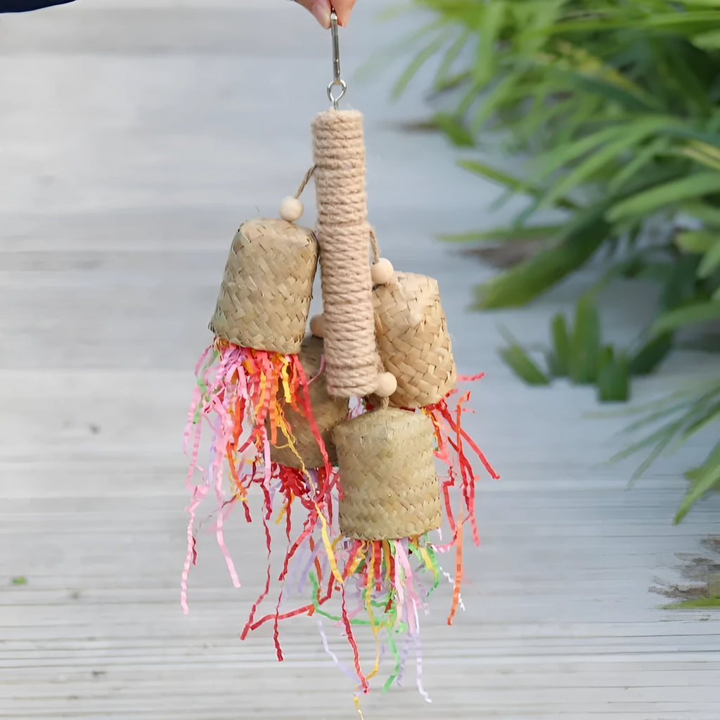Colourful shredded paper and wood parrot hanging toy with sisal rope, 15 by 35 cm