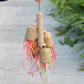 Colourful shredded paper and wood parrot hanging toy with sisal rope, 15 by 35 cm