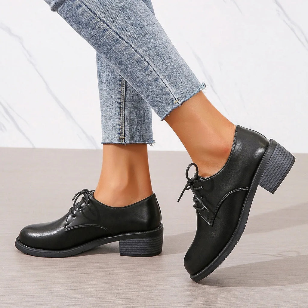 Black women's low-top shoes with a chunky mid-height heel and round toe.