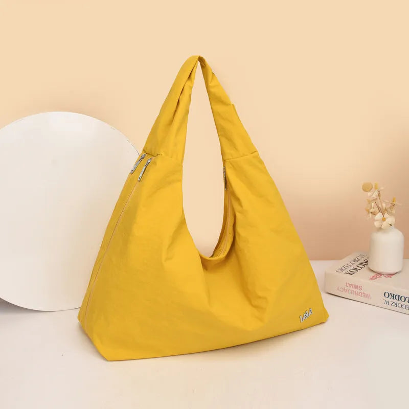 Soft nylon heart-shaped underarm bag for women in black, blue, khaki, or yellow.