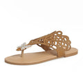 Gold women's slip-on sandals with rhinestone detail on the flip-toe strap and a flat rubber sole.
