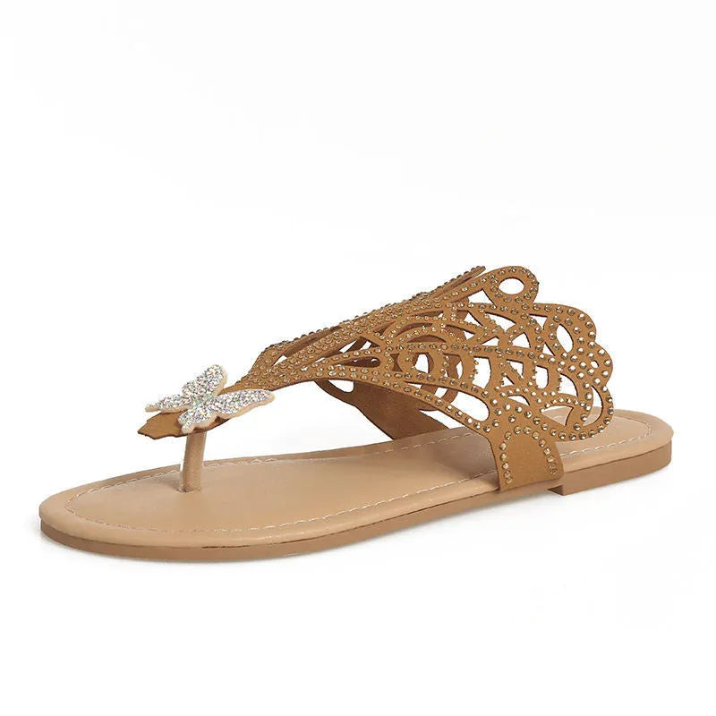 Gold women's slip-on sandals with rhinestone detail on the flip-toe strap and a flat rubber sole.