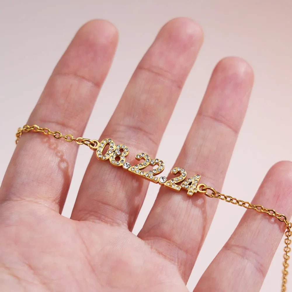 Stainless steel digital bracelet with diamond-studded numbers on display.