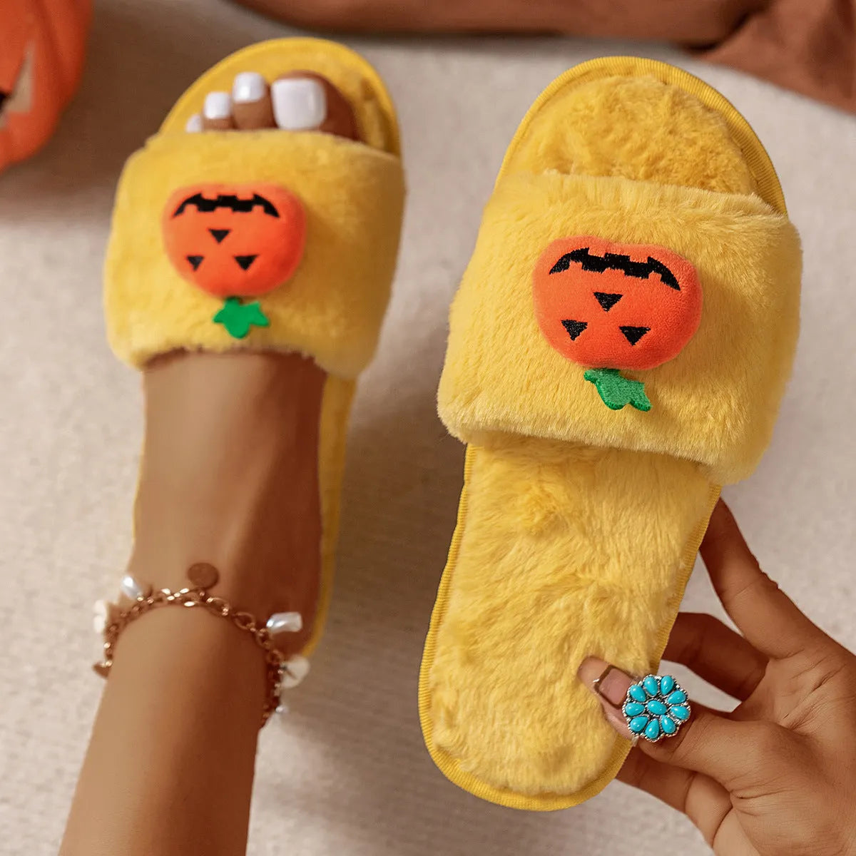 White and yellow Halloween pumpkin plush slippers with open toe and synthetic fur upper