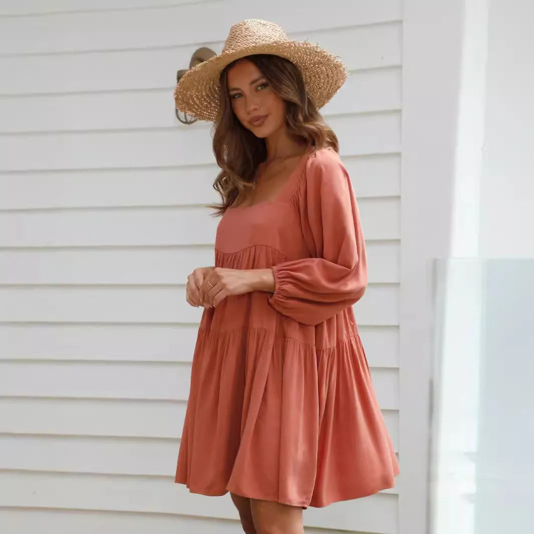 Orange children's backless dress with square collar and puff sleeves, showing A-line skirt.