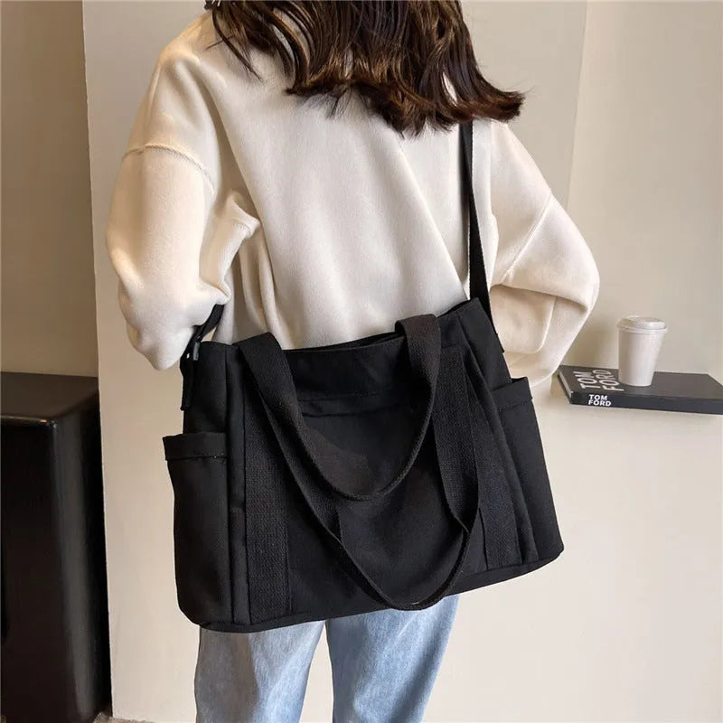 Large capacity shoulder canvas tote bag in solid colour with external sandwich pocket