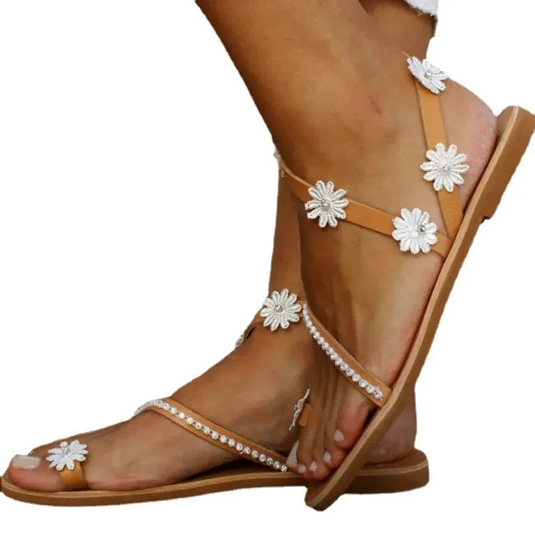 Brown ladies Roman sandals with floral decoration on PU upper and flat rubber sole