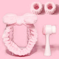 Facial brush and hair band set in coral fleece material with nylon bristles and plastic handles