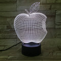 3D fruit-shaped colourful LED night light with touch control on a surface.
