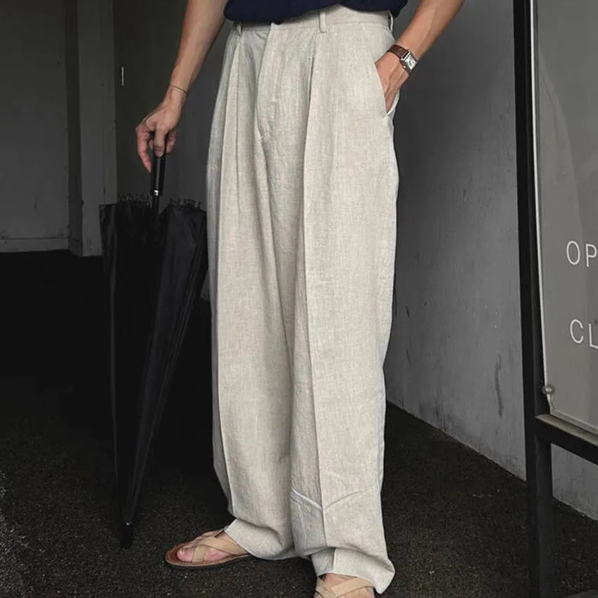 Men's loose fit cotton linen trousers in apricot, army green, and purplish blue, showing pencil leg opening.