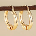 Geometric copper earrings for women with ring and line details in golden colour.