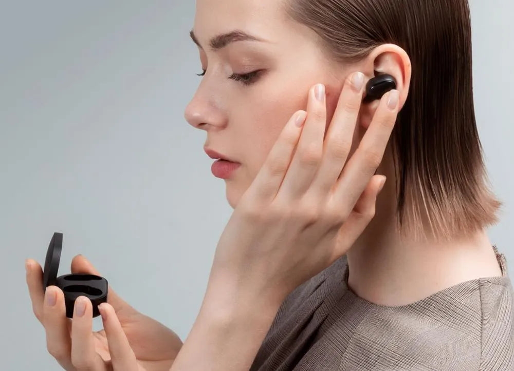 Redmi AirDots True Wireless black earbuds and charging case on a white background.