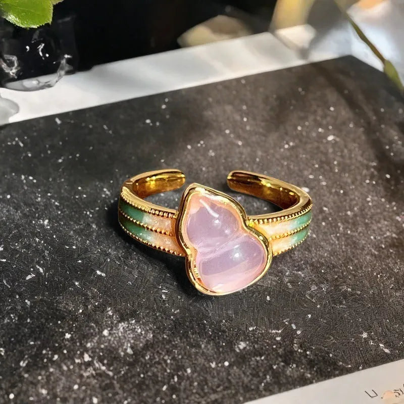 Adjustable copper ring with vintage oil dripping gourd, flower, and bow design and inlaid zircon stones.