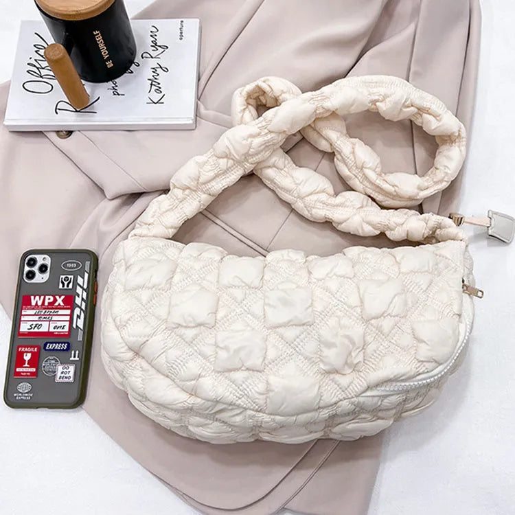 Women's light beige nylon underarm messenger bag with a long shoulder strap.