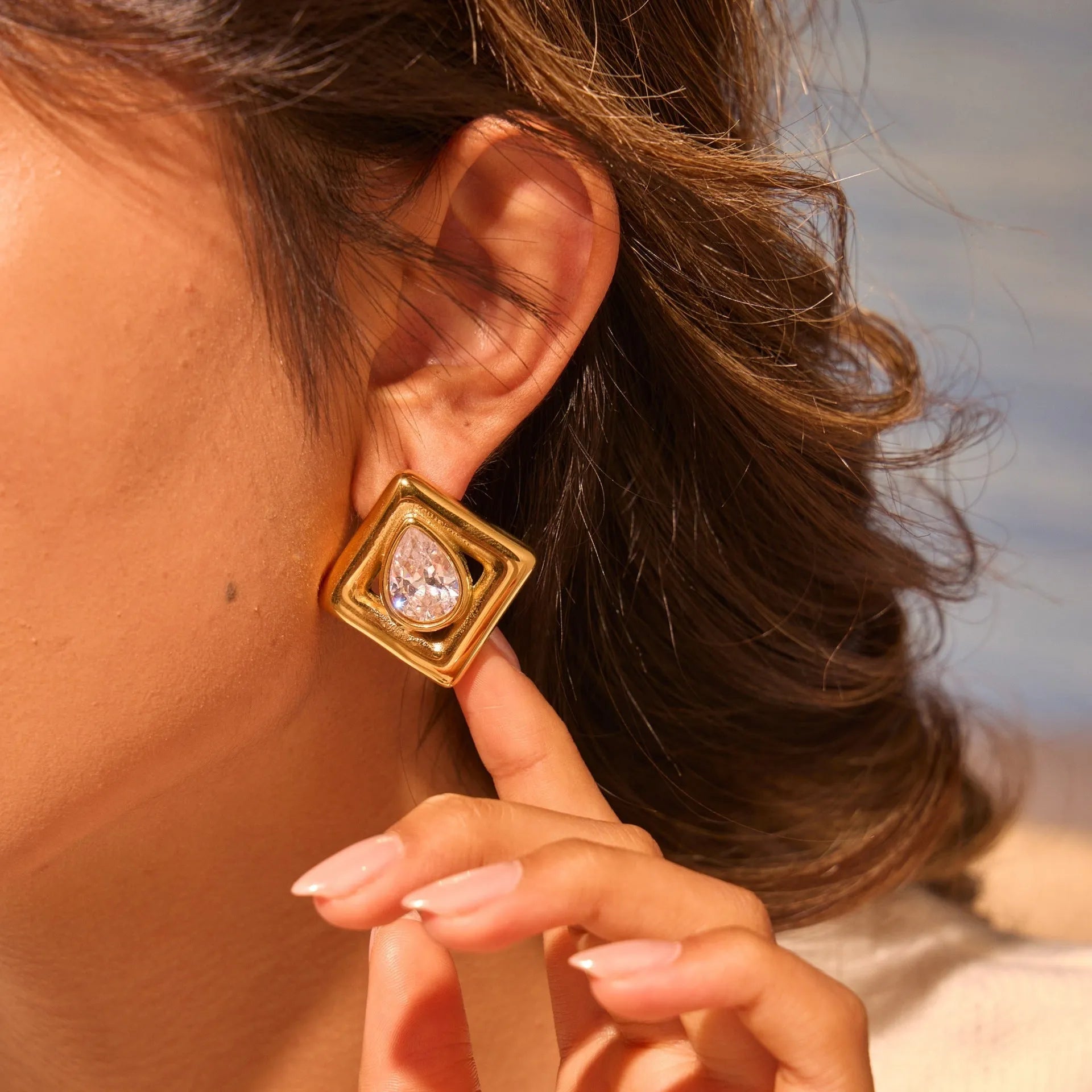 Gold electroplated stainless steel stud earrings with water drop zircon design