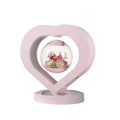 Pink preserved rose in ABS PC PVC ornament with Bluetooth base on tabletop