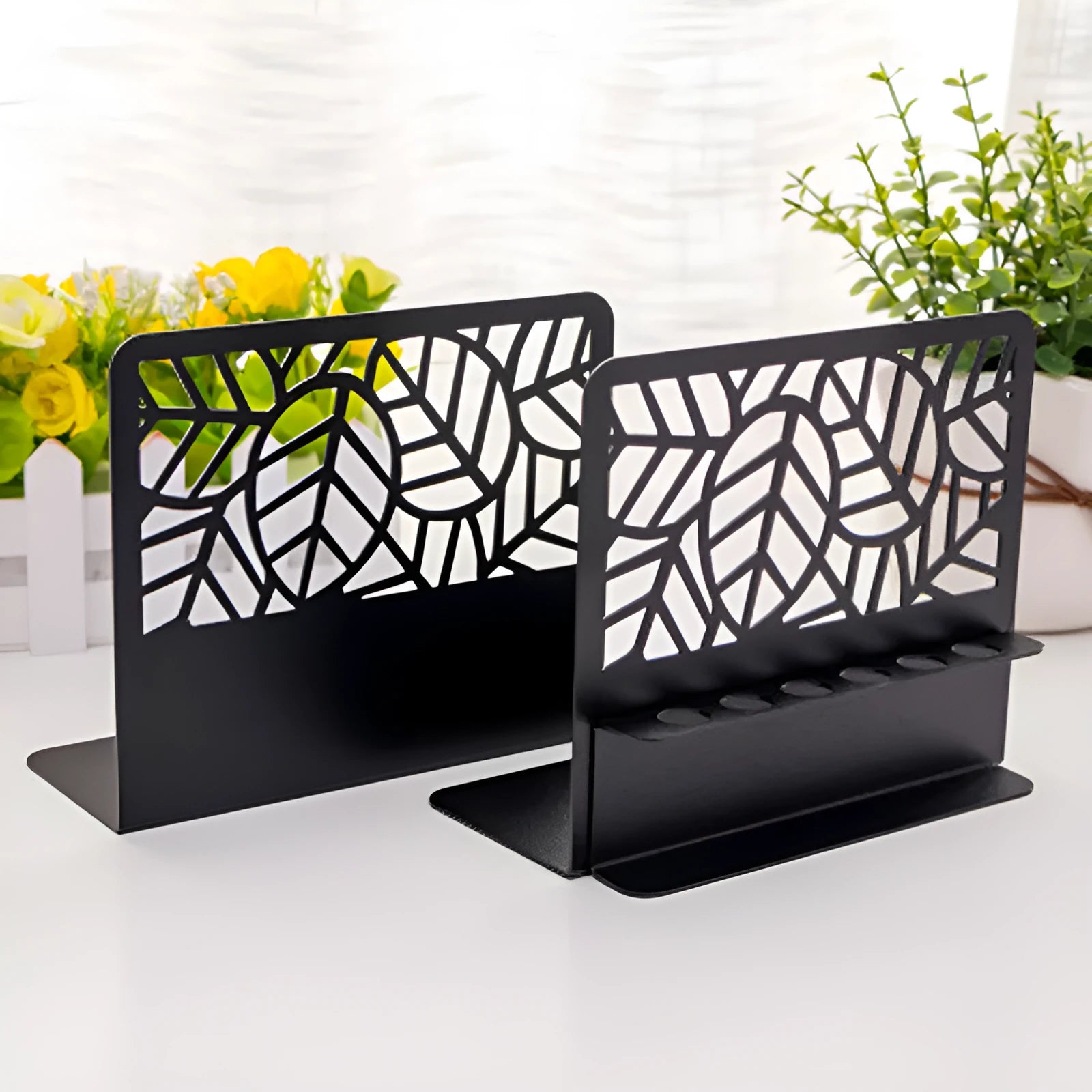 Pair of white steel Nordic bookends with six-hole pen holder and Japanese hollow design on a wooden desk