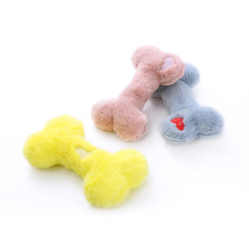 Blue pink and yellow plush bone dog toy with a textured grinding teeth surface.