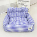 Grey and blue plaid car-mounted removable pet travel nest for dogs on a car seat