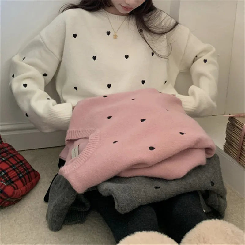 Women's loose-fit acrylic pullover sweater with embroidered love pattern in milky white.