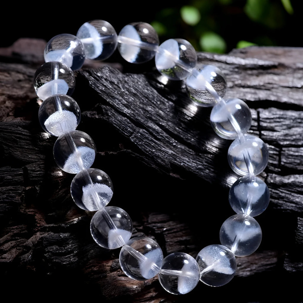 Women's natural white ghost pyramid crystal bracelet showing textured surfaces and ruyi charm detail