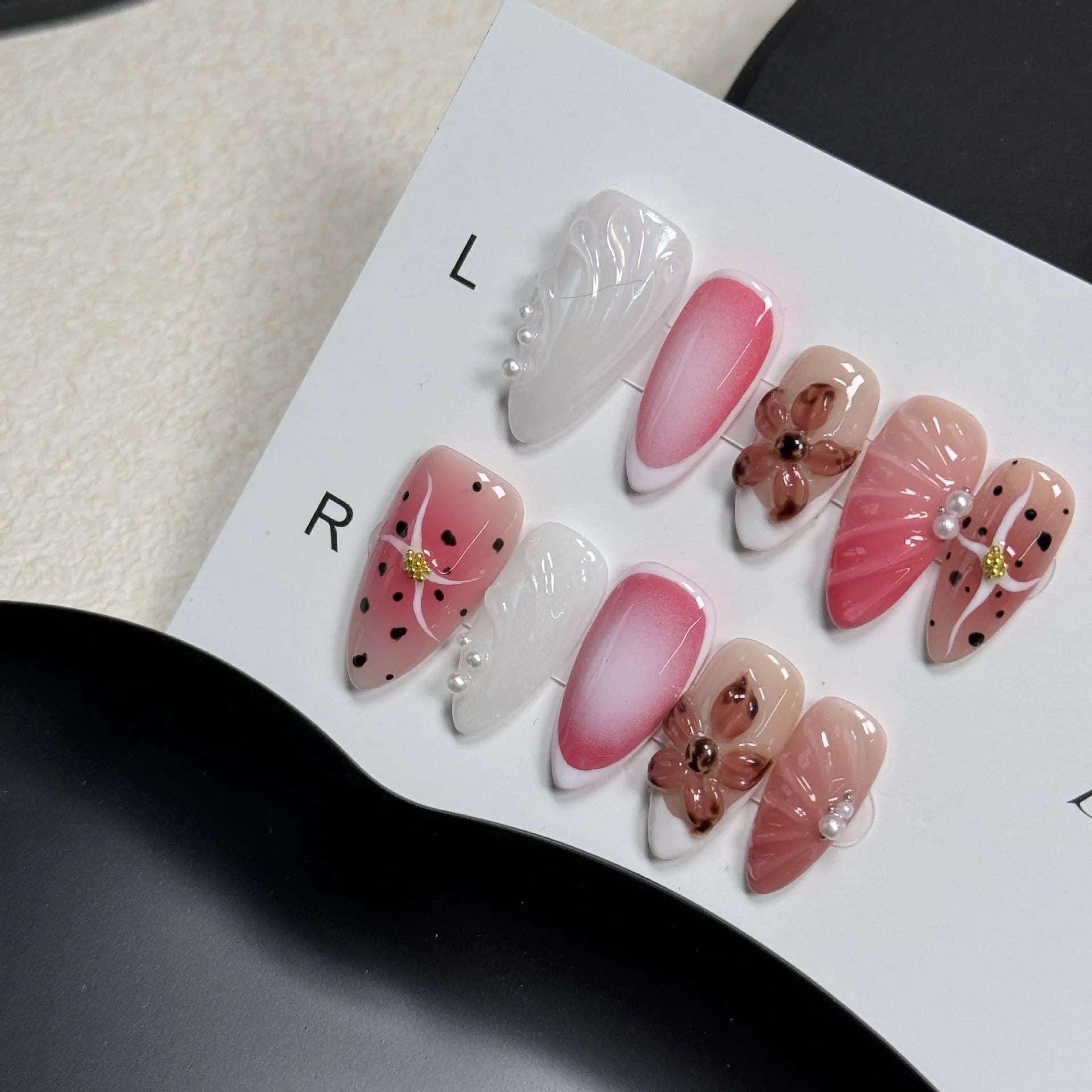Hand-painted 3D nail patches with embossed candy patterns in almond shape on plastic armour suit
